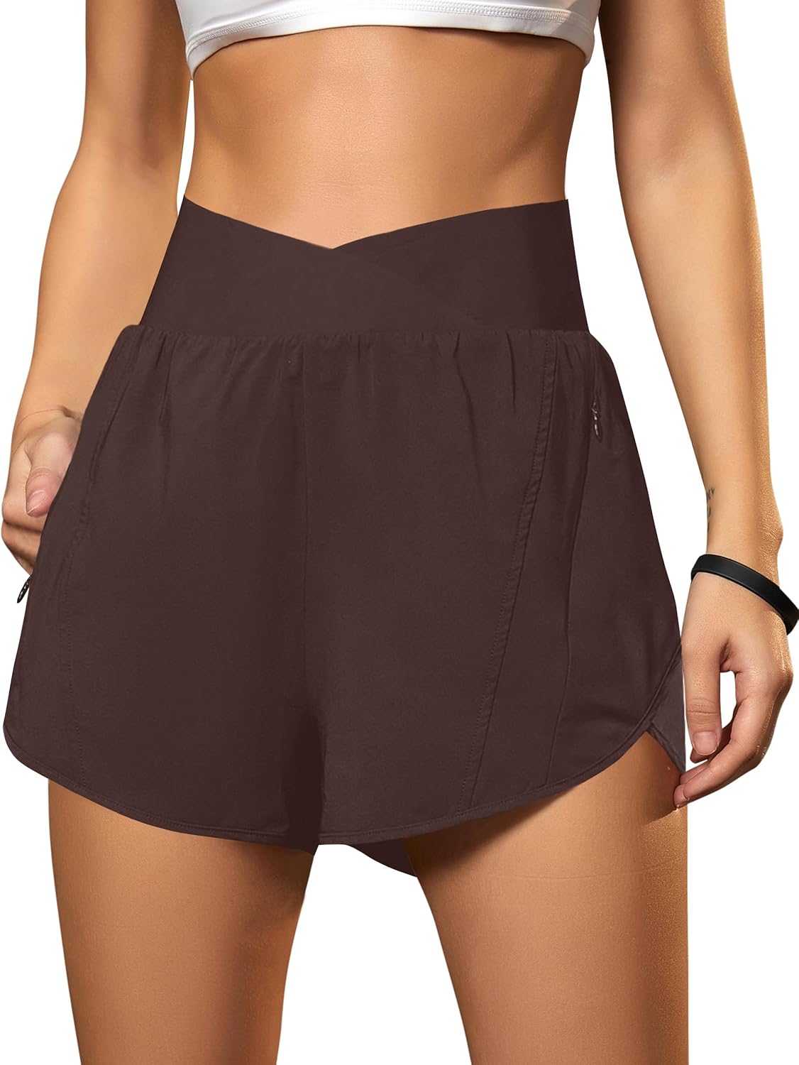 Black crossover high-waisted running shorts with zippered pockets and four-way stretch fabric โ view 5