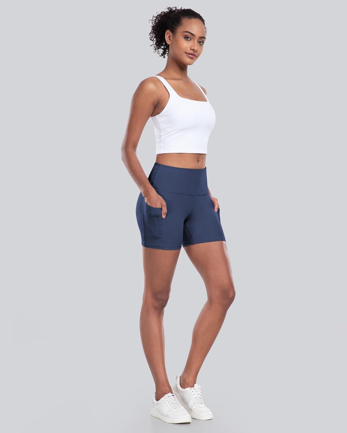 High-waisted biker yoga shorts in {color} with side pockets and squat-proof compression fabric — view 4