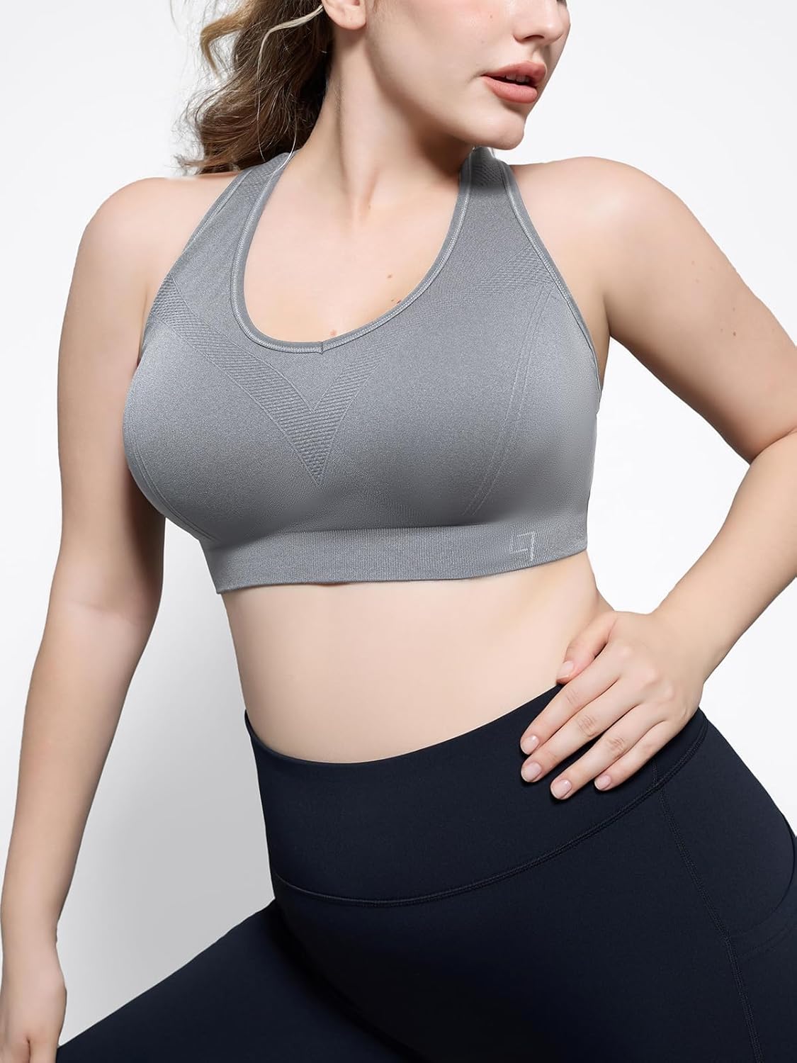 Black padded racerback sports bra with seamless construction, front view showing supportive fit — view 2