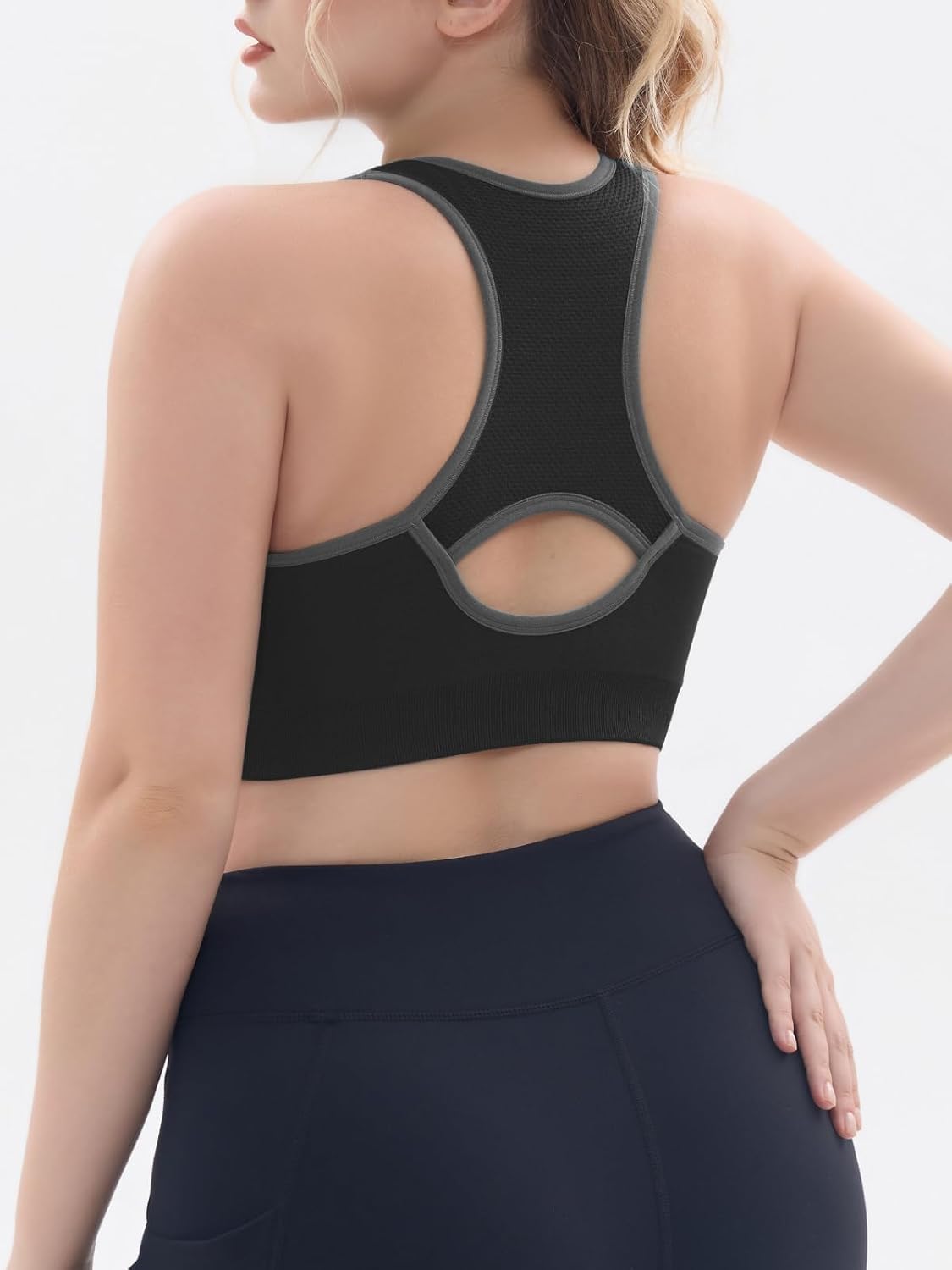 Black padded racerback sports bra with seamless construction, front view showing supportive fit — view 3