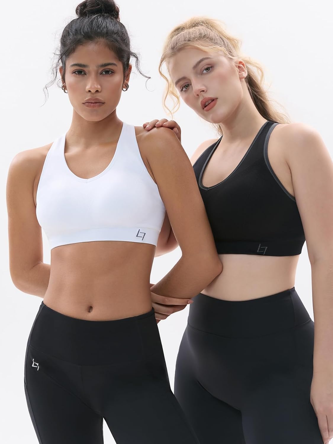 Black padded racerback sports bra with seamless construction, front view showing supportive fit — view 4