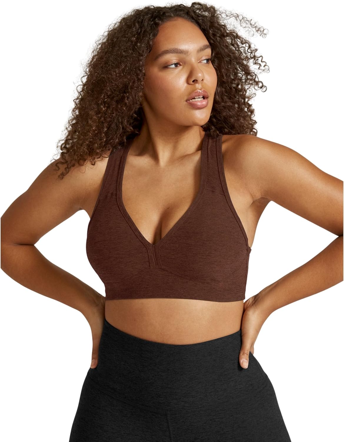Spacedye multi-color yoga bra with fitted support, shown front view on model during yoga practice — view 1