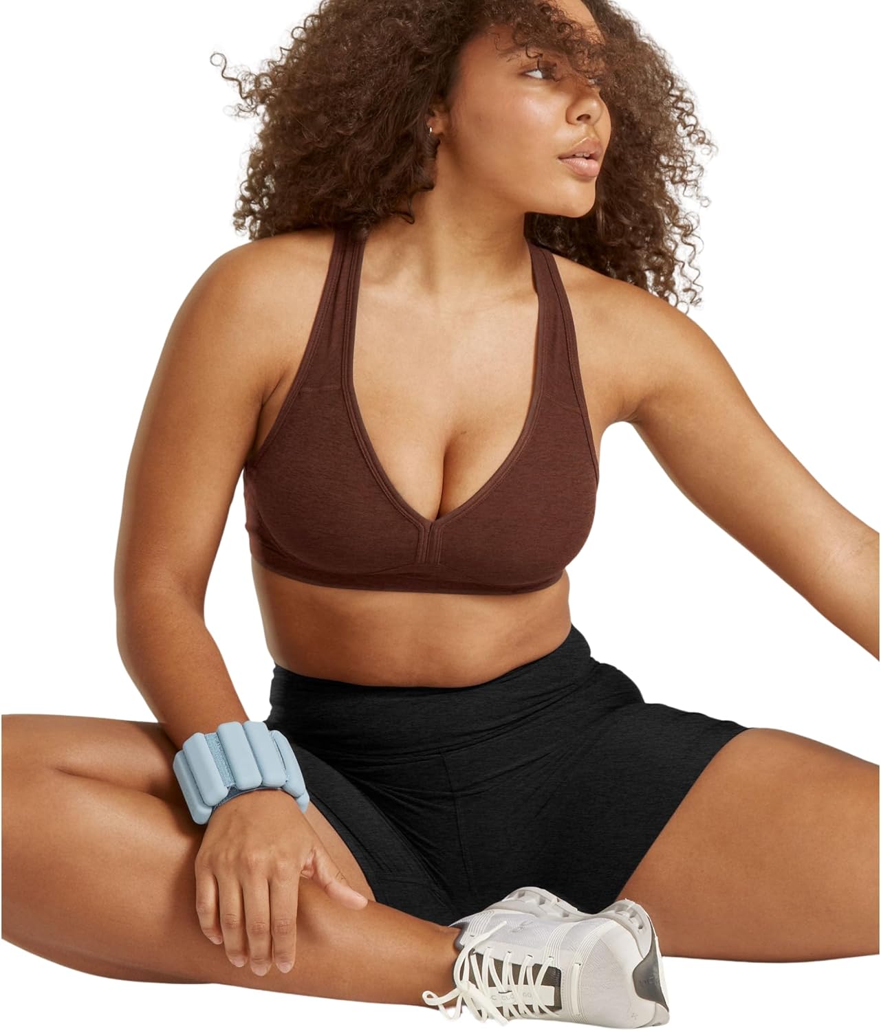 Spacedye multi-color yoga bra with fitted support, shown front view on model during yoga practice — view 4