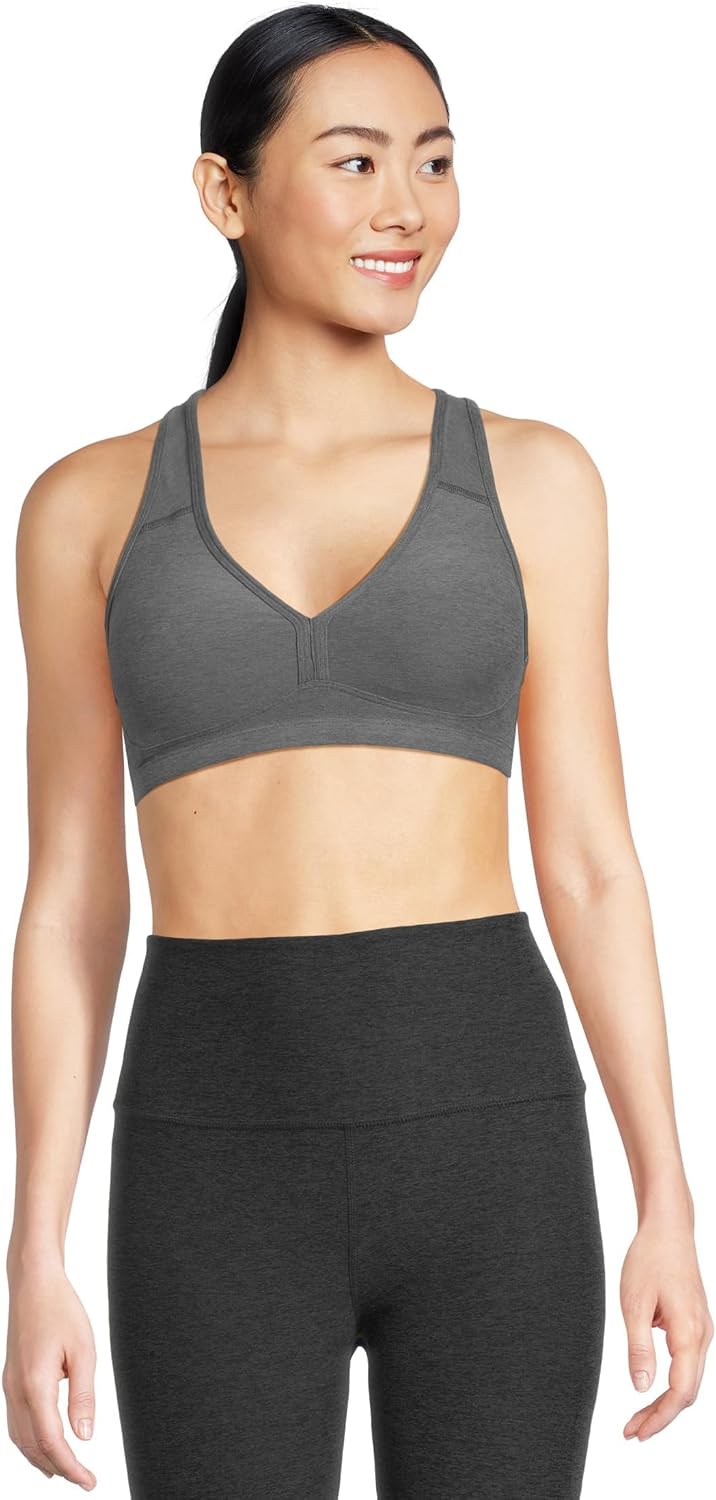Spacedye multi-color yoga bra with fitted support, shown front view on model during yoga practice — view 1