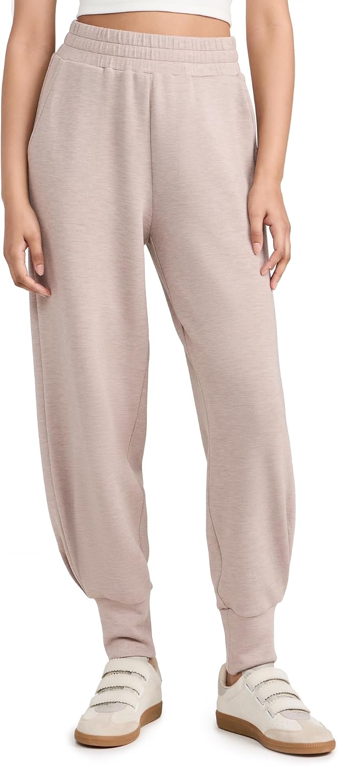 Black relaxed joggers with soft brushed fleece and moisture-wicking fabric, shown on model in athleisure setting — view 1