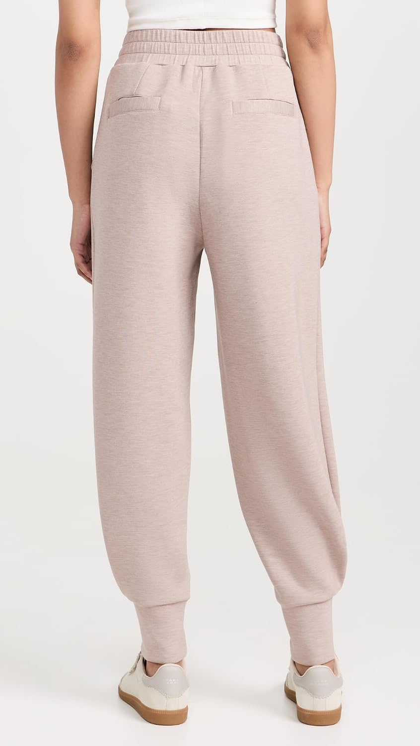 Black relaxed joggers with soft brushed fleece and moisture-wicking fabric, shown on model in athleisure setting — view 4