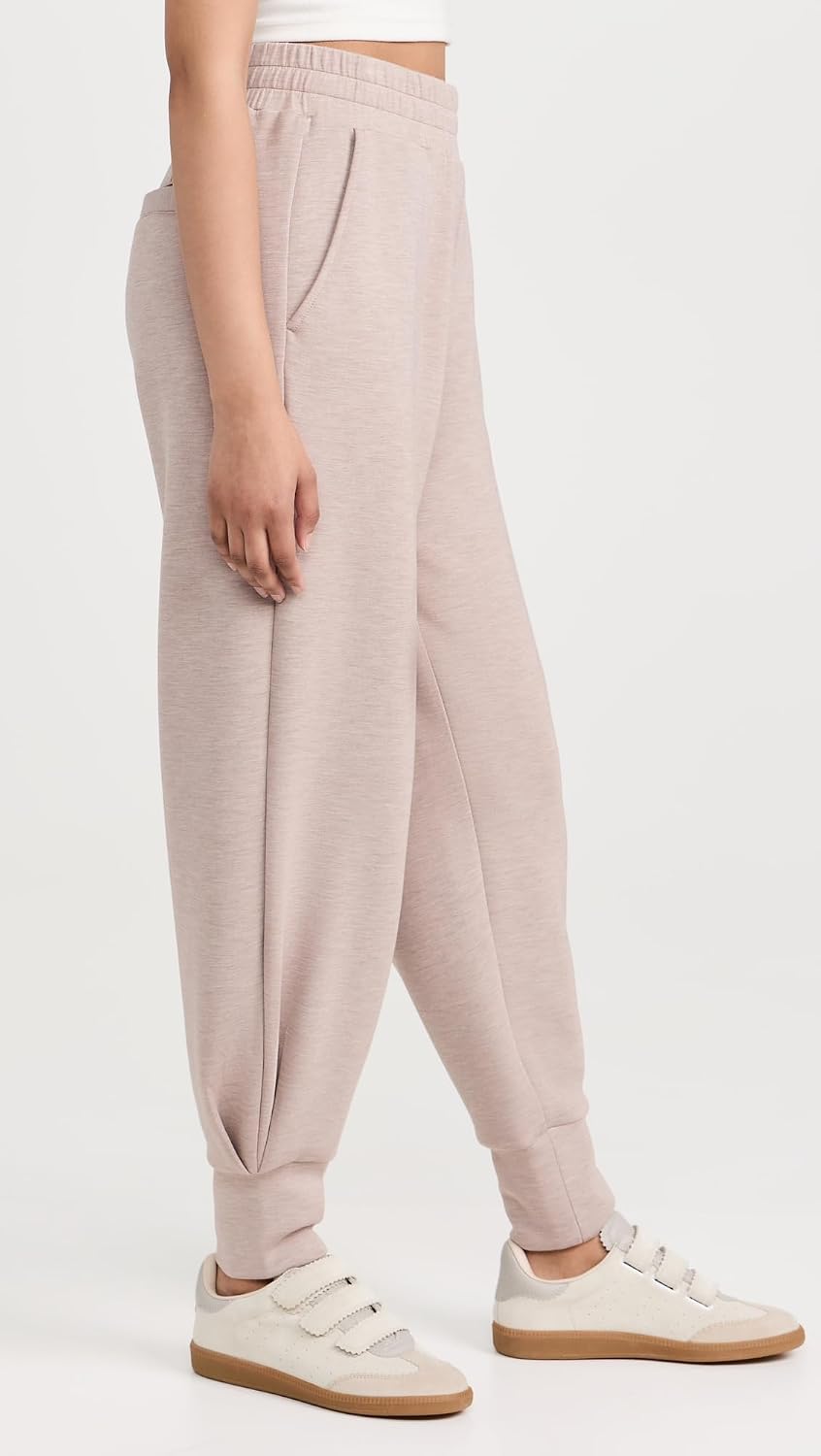 Black relaxed joggers with soft brushed fleece and moisture-wicking fabric, shown on model in athleisure setting — view 1