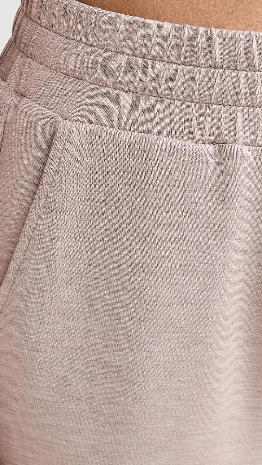 Black relaxed joggers with soft brushed fleece and moisture-wicking fabric, shown on model in athleisure setting — view 2