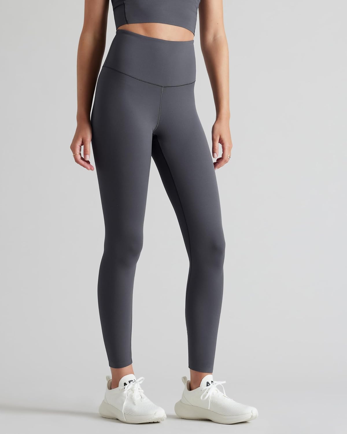 Black high-waisted 7/8 yoga leggings with moisture-wicking fabric, front view — view 2