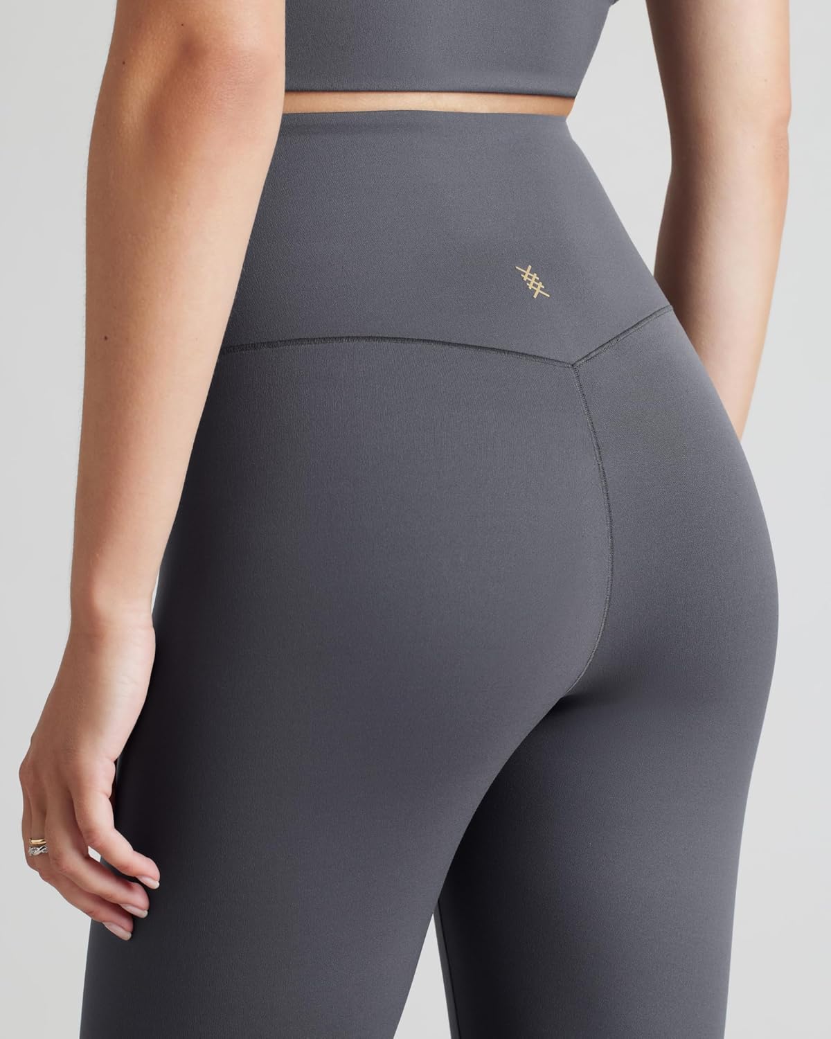 Black high-waisted 7/8 yoga leggings with moisture-wicking fabric, front view — view 2