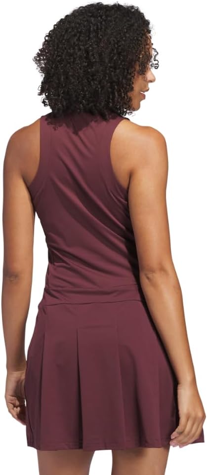 Black pleated golf dress with moisture-wicking four-way stretch fabric, front view — back
