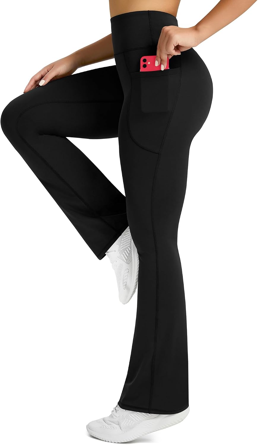 Black high-waisted flare yoga pants with functional side pockets and four-way stretch fabric โ view 2
