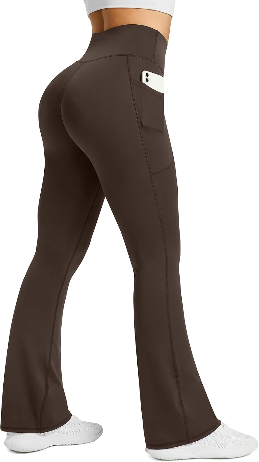 Black high-waisted flare yoga pants with functional side pockets and four-way stretch fabric โ view 4